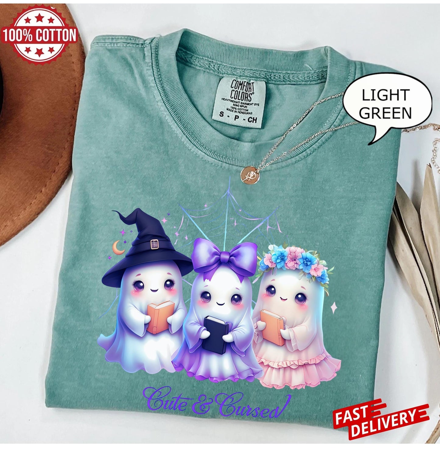 White cotton t-shirt with a centered graphic print. The illustration features three kawaii-style mice: on the left, a gray mouse wearing a black witch hat and holding an orange pumpkin; in the middle, a white mouse with a large pink bow; on the right, a brown mouse with an autumn floral crown. The design uses soft, pastel colors, creating a cheerful and whimsical Halloween vibe.